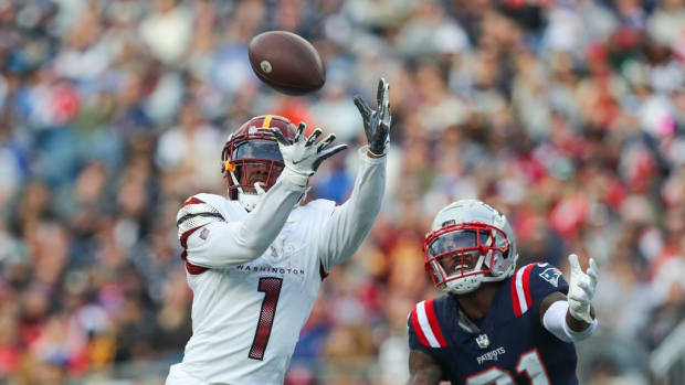 Washington Commanders receiver Jahan Dotson (1) catches a pass for a touchdown during the second half against the New England Patriots at Gillette Stadium.